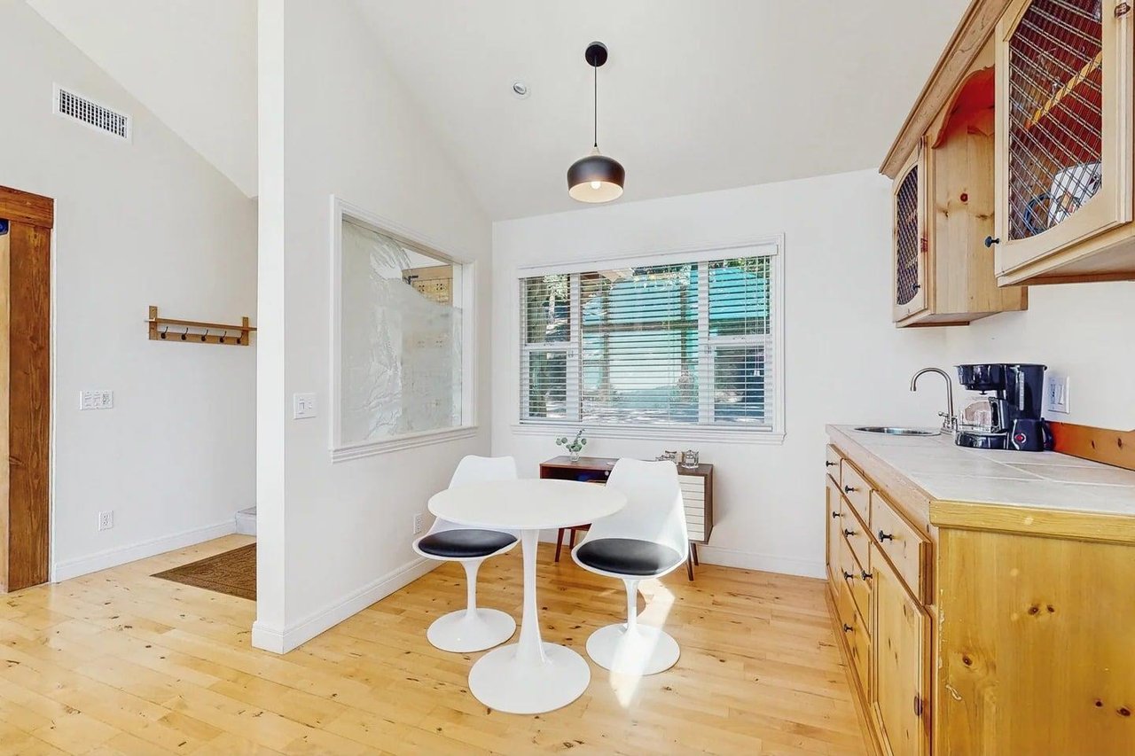 Drip coffee maker on the wet bar and small breakfast nook with seating for 2.
