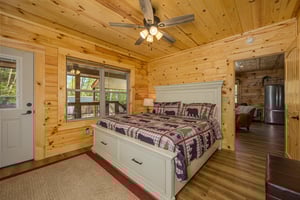 King bed with window and door to deck