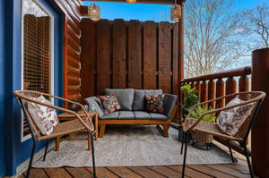 Unwind on your private balcony with stylish wicker seating, soft cushions, and warm pendant lighting creating the perfect outdoor retreat.