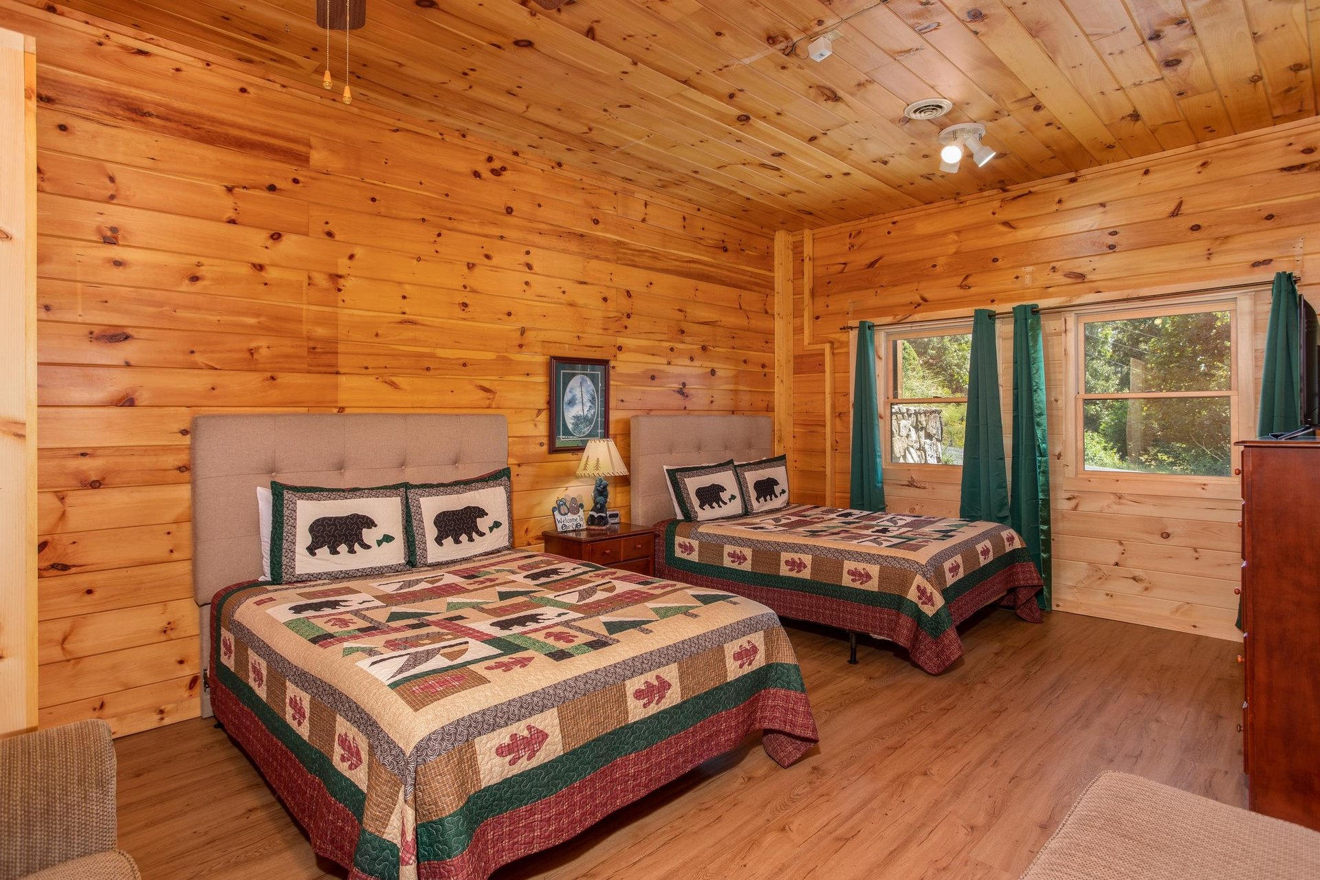 Two queen beds with tufted headboards at Cabin Fever, a 4bedroom cabin rental located in Pigeon Forge