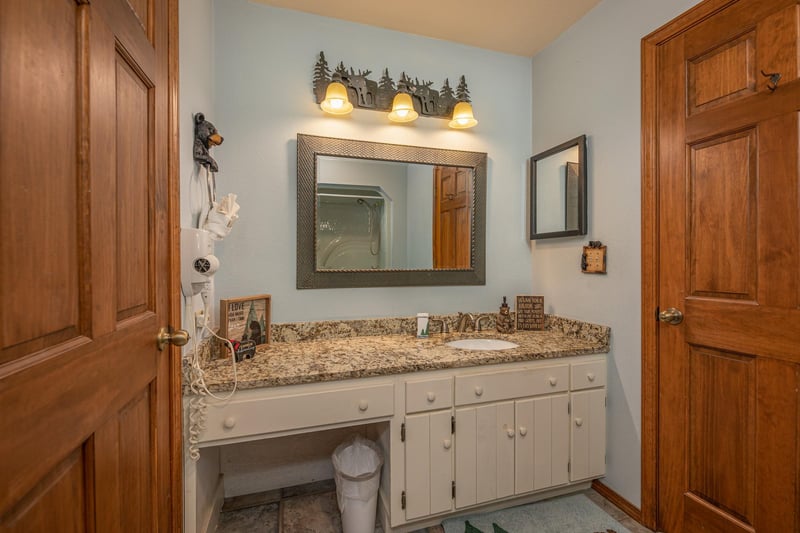 Vanity and dressing area in a bathroom at Lazy Bear Retreat, a 4 bedroom cabin rental located in Pigeon Forge