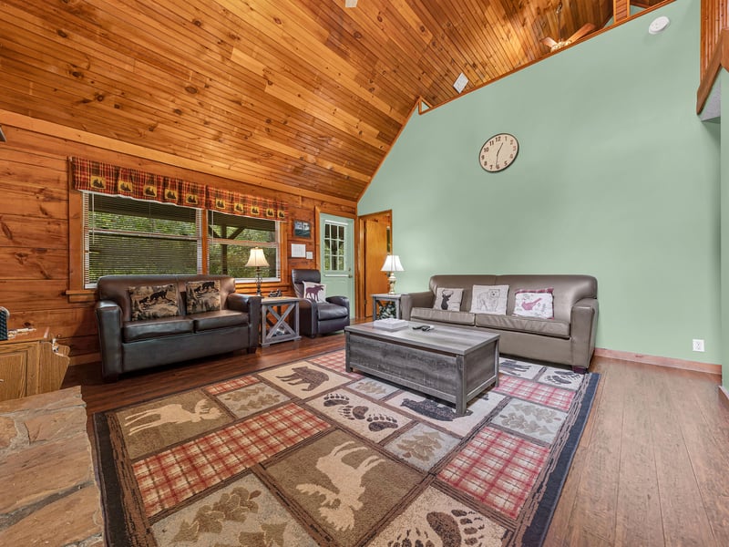 Sink into plush leather sofas surrounded by warm wood and rustic charm in this cozy living space designed for relaxation.