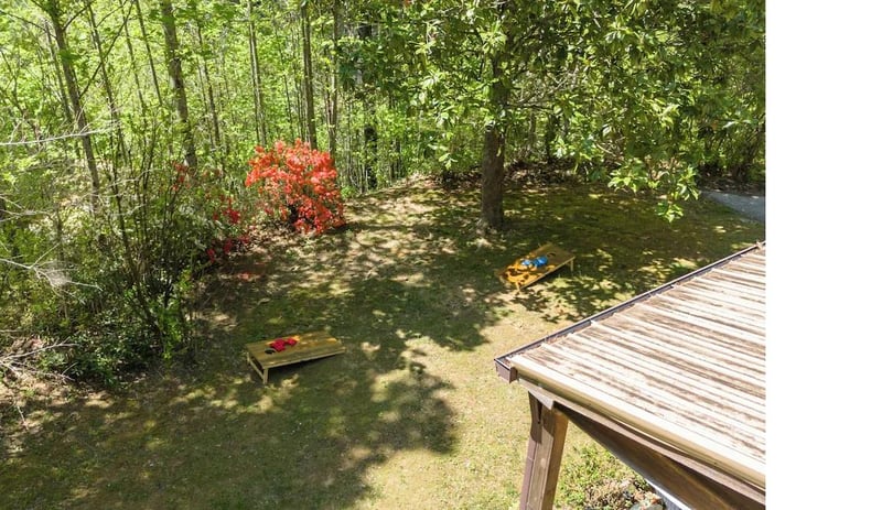 Your private garden oasis awaits with a shaded lawn perfect for morning coffee or afternoon relaxation beneath the canopy.