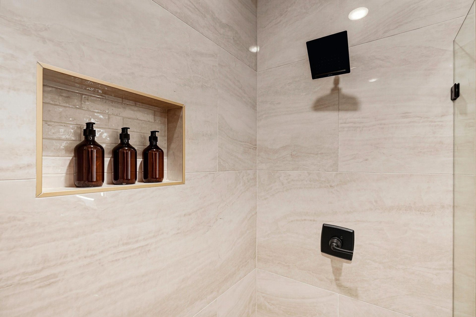 Slip into your private rainfall shower with spaquality amenities awaiting you in the builtin niche—luxurious touches that make every rinse feel like a retreat.
