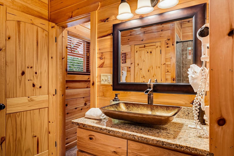 Freshen up in your rustic bathroom, where warm knotty pine and a striking bronze vessel sink create a cabin escape youll love returning to after each adventure.