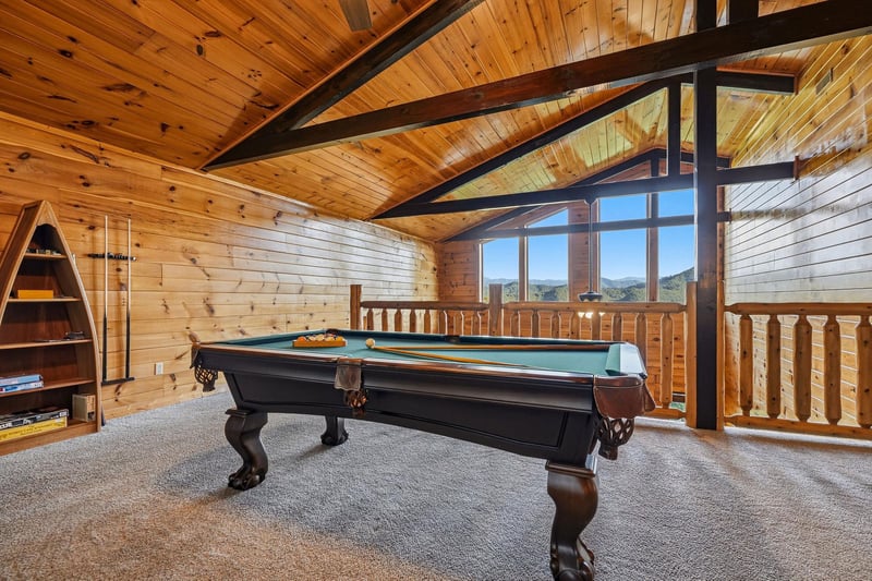 Challenge your friends to a game in this stunning loft game room, where soaring vaulted ceilings and mountain views create the perfect backdrop for friendly competition and laughter.