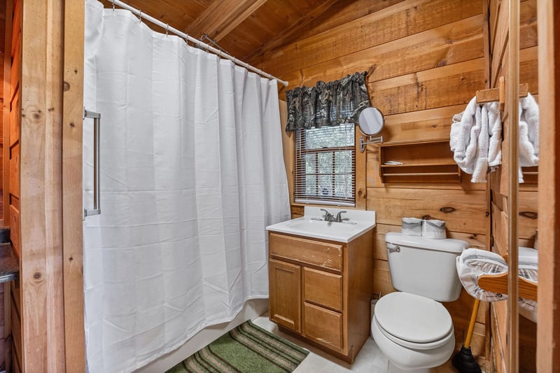 Bathroom with a tub and shower at Beary Good Time, a 1bedroom cabin rental located in Pigeon Forge