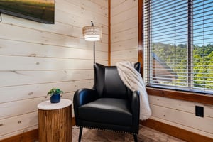 Sink into your favorite armchair by the window and let natural light warm your reading nook—this cozy corner invites you to unwind with a good book or simply daydream.