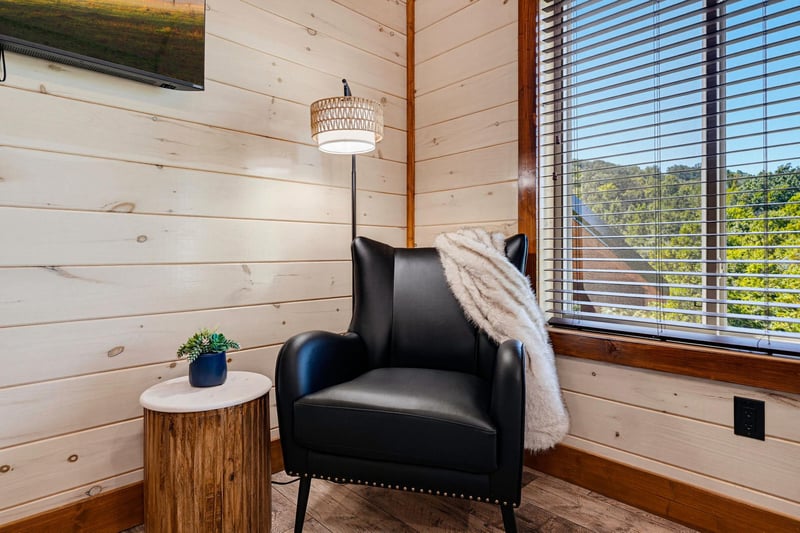 Sink into your favorite armchair by the window and let natural light warm your reading nook—this cozy corner invites you to unwind with a good book or simply daydream.