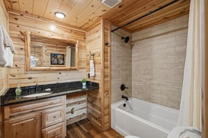 Wrap yourself in fresh towels after soaking in your private tubshower combo, nestled in warm rustic wood and tile finishes that make every refresh feel like a peaceful retreat.
