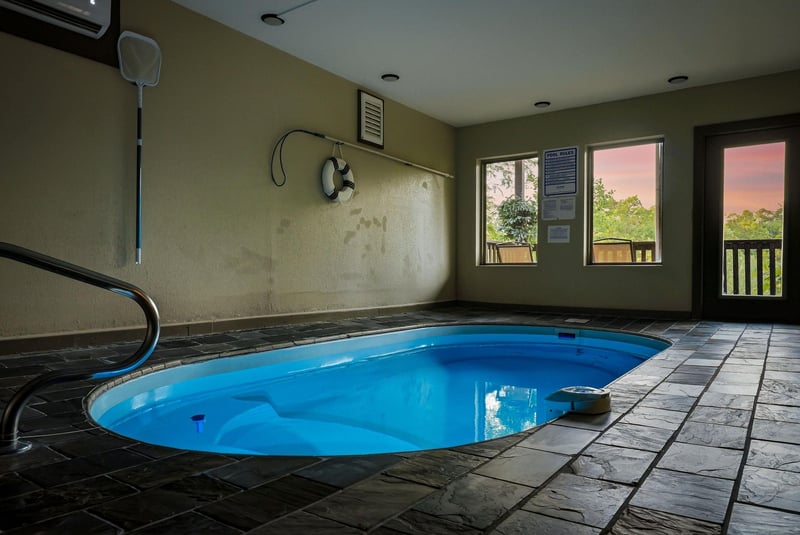 Unwind in your private indoor pool sanctuary, where crystalclear waters await beneath soaring ceilings and large windows frame peaceful sunset views.