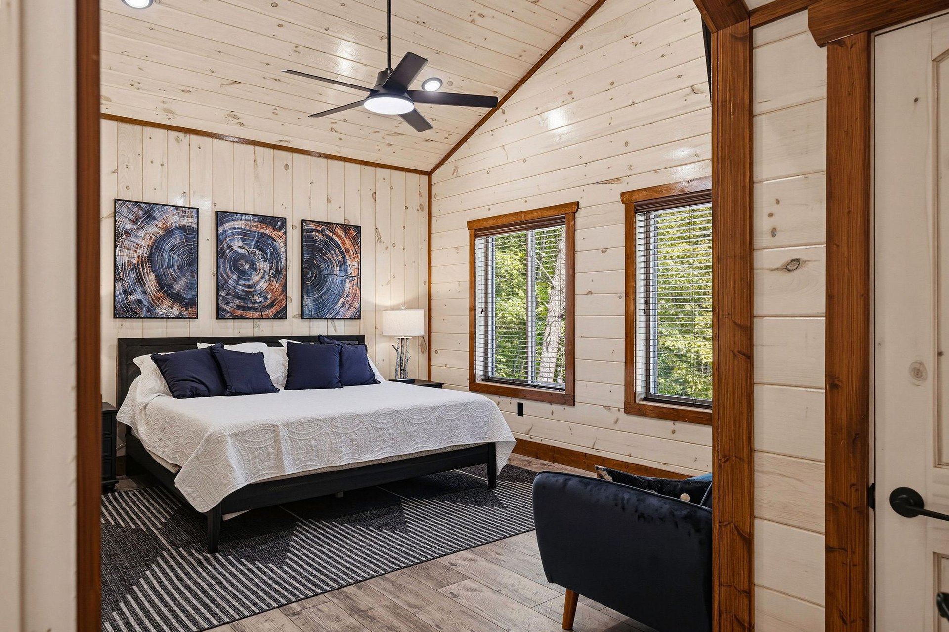 Unwind in your serene bedroom, where vaulted ceilings and warm wood create a cozy retreat. Natural light streams through double windows, inviting peaceful mornings and restful nights in this tranquil 