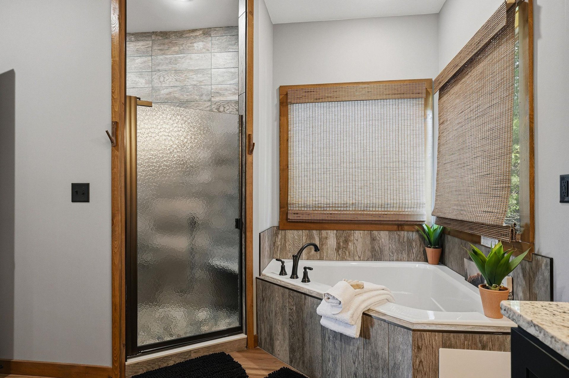 Slip into the soaking tub after a long day exploring, with natural light filtering through woven shades and a separate tiled shower ready whenever you need it.