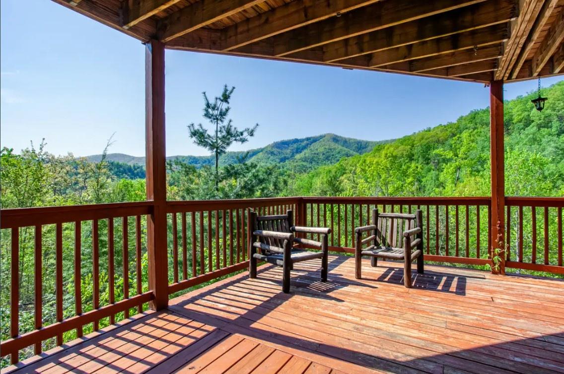 Your private covered deck offers sweeping mountain views and rustic seating—perfect for morning coffee or sunset unwinding.