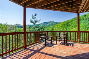 Your private covered deck offers sweeping mountain views and rustic seating—perfect for morning coffee or sunset unwinding.