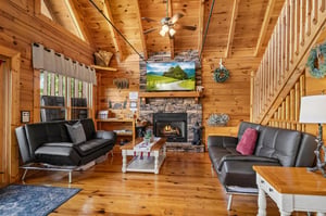 Living room with 2 futons and stone fireplace