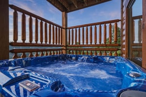 Soak away your cares in your private hot tub while taking in panoramic mountain and lake views from your covered balcony.