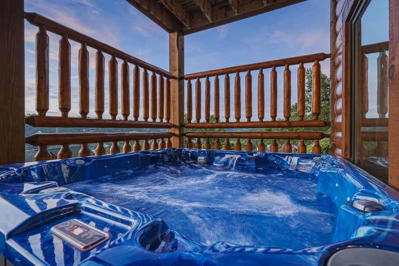 Soak away your cares in your private hot tub while taking in panoramic mountain and lake views from your covered balcony.