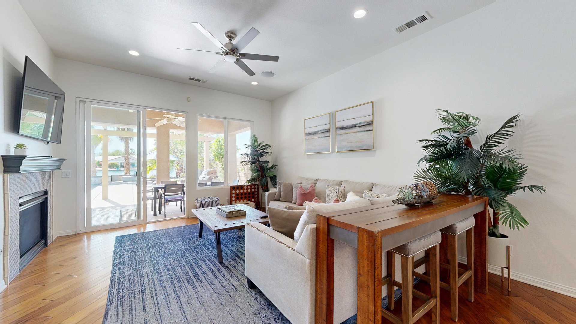 Living room includes direct patio access where water and mountain views can be seen.