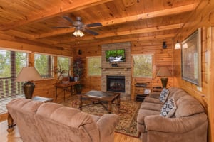Living room with a fireplace and TV at Howlin in the Smokies, a 2 bedroom cabin rental located in Pigeon Forge