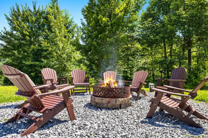 Gather around the fire pit with friends and family, sinking into Adirondack chairs as the flames crackle and nature surrounds this peaceful outdoor retreat.