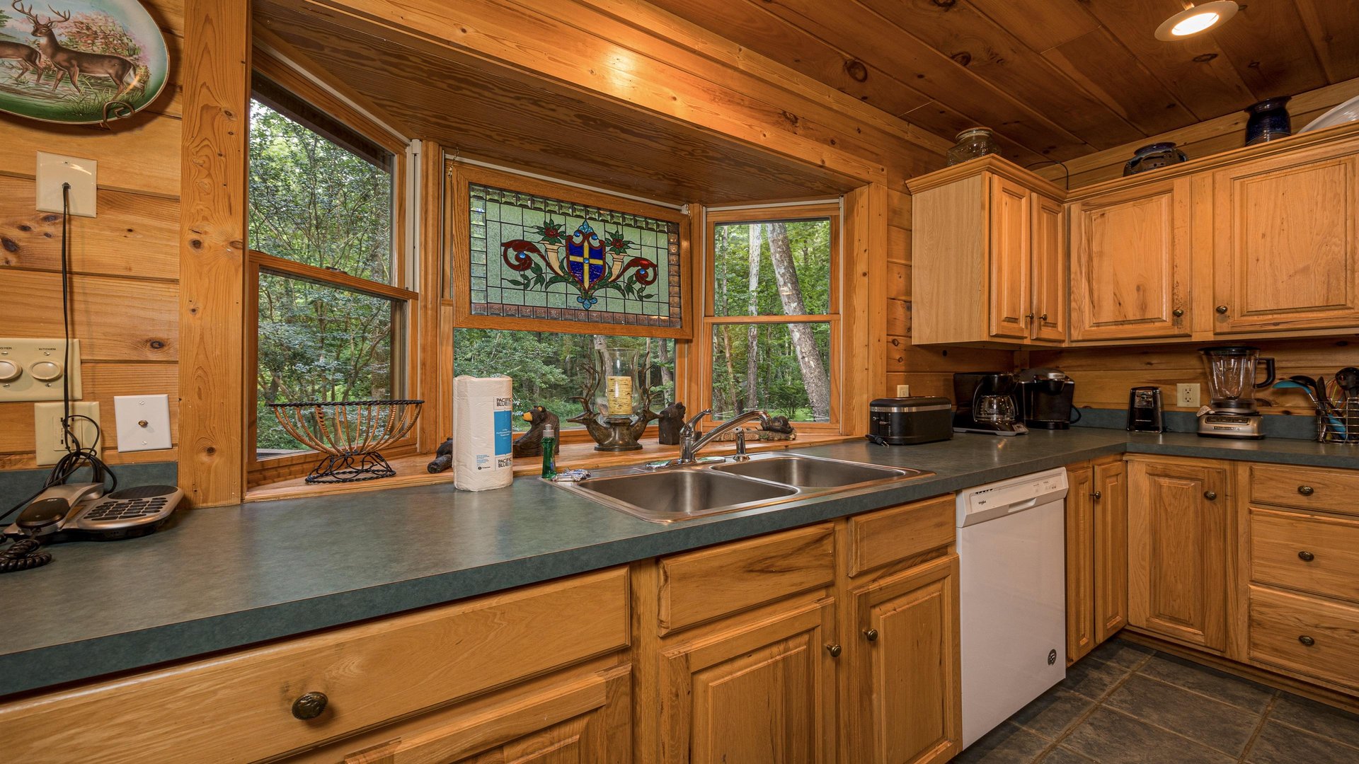 Kitchen cabinets and sink with stained glass window