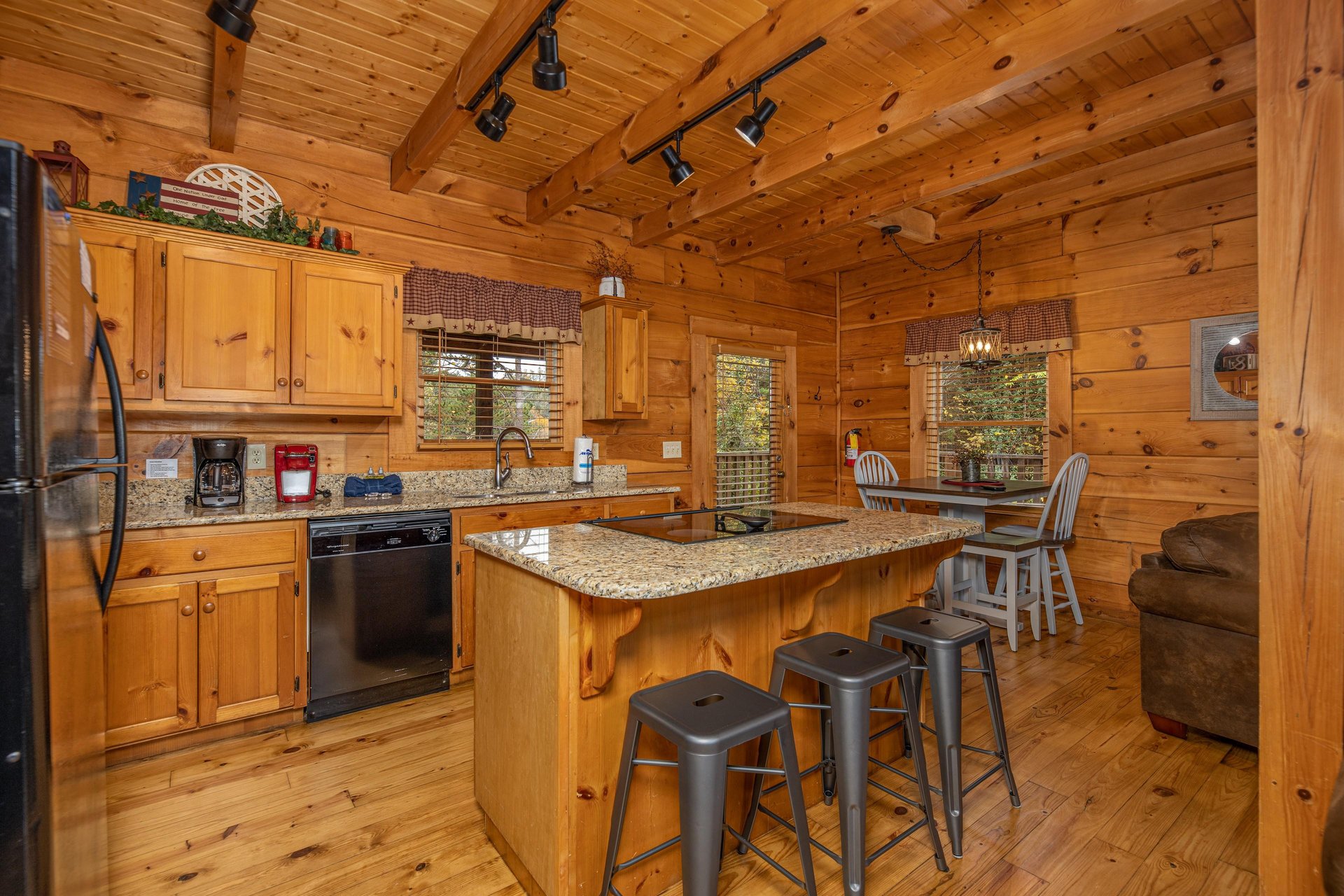 Kitchen with black appliances and granite counters at Livin Simple, a 2 bedroom cabin rental located in Pigeon Forge