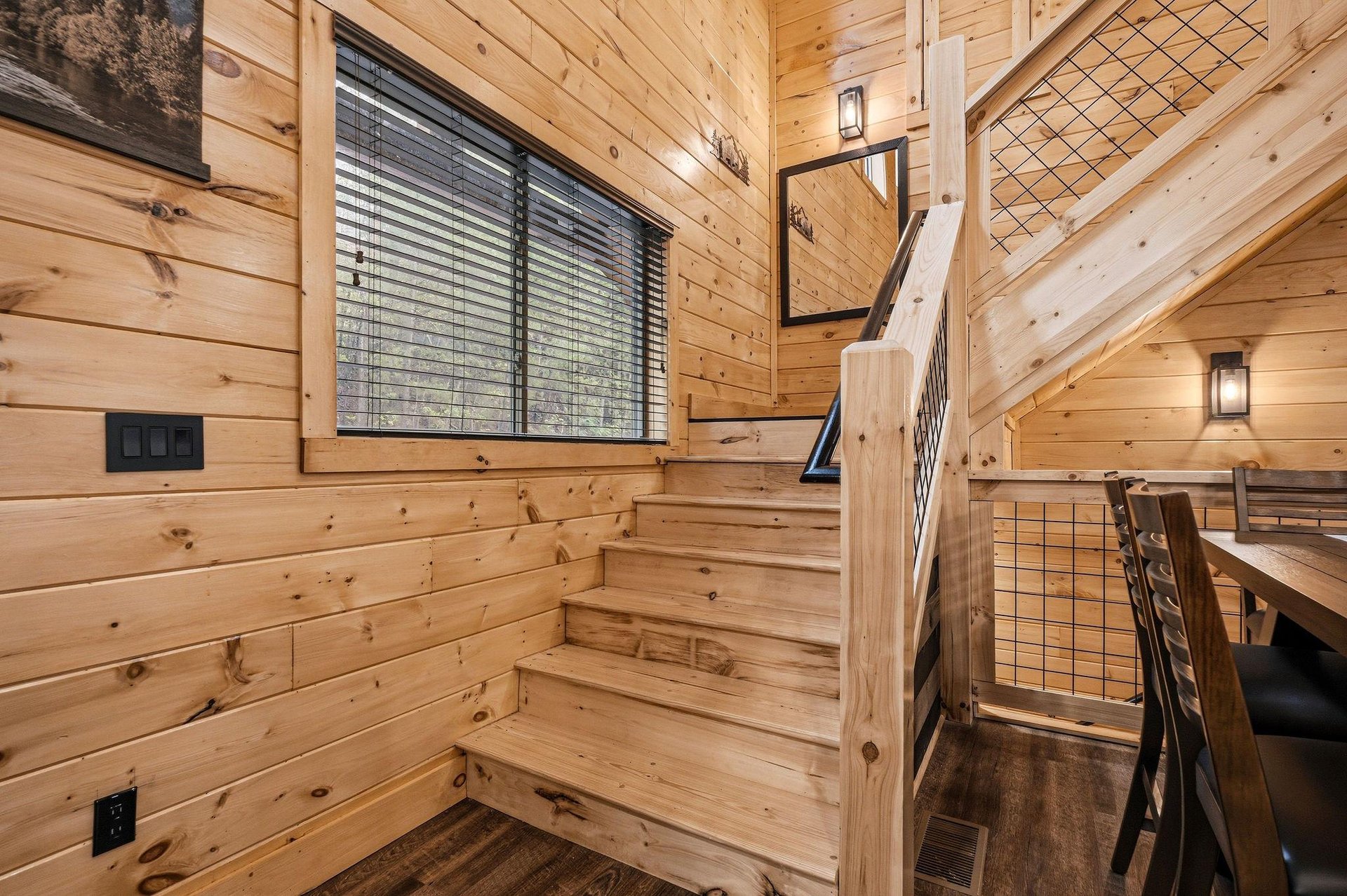 Ascend these handcrafted wooden stairs where rustic charm meets modern comfort in your cozy cabin retreat.