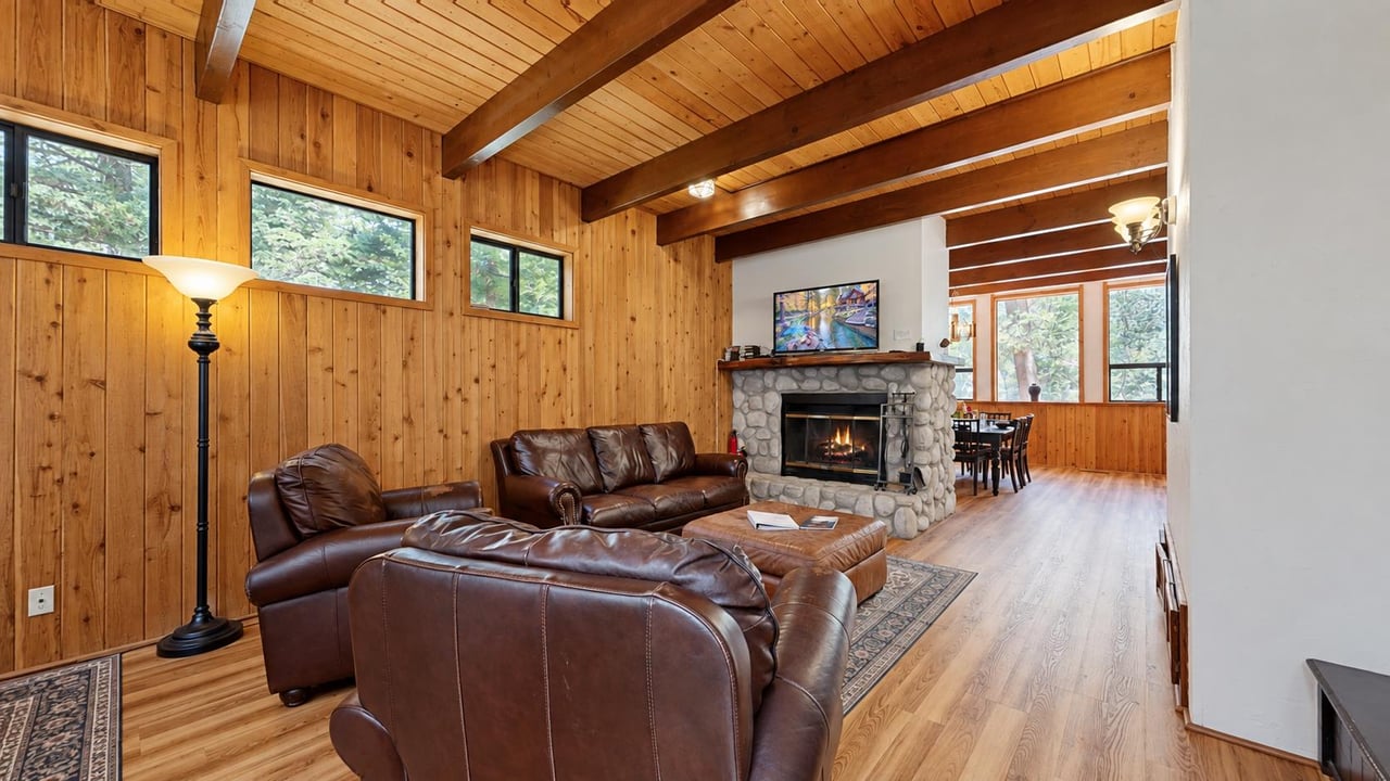 Gather around the stone woodburning fireplace on chilly Idyllwild nights, or let the open layout carry you straight into the dining area — this living room was made for togetherness.