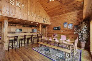 Step into your rustic mountain retreat where warm wood surrounds you and the open kitchen flows seamlessly into your dining space.