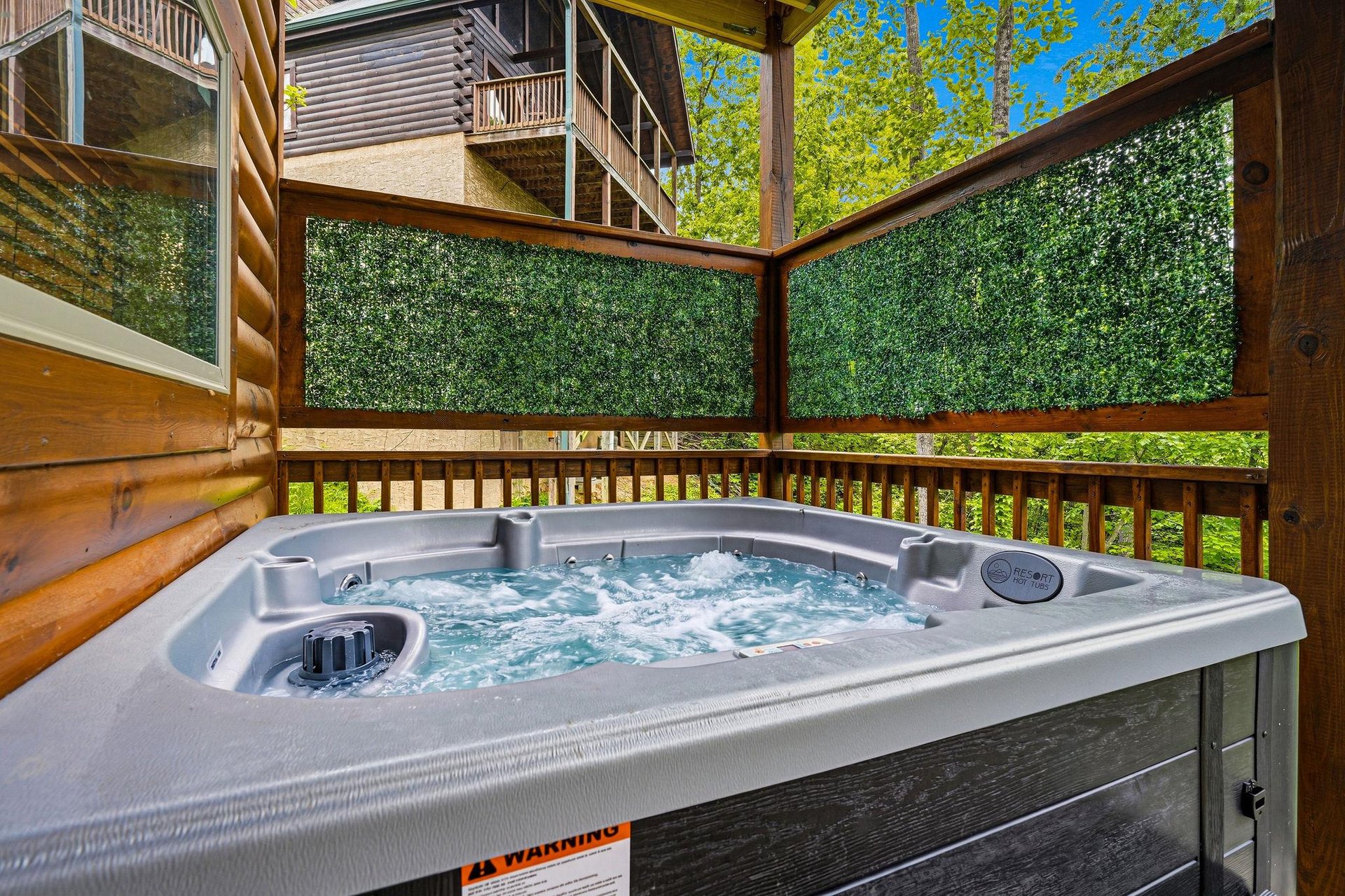 Soak your stress away in your private hot tub, nestled on a secluded deck surrounded by lush greenery and mountain charm.