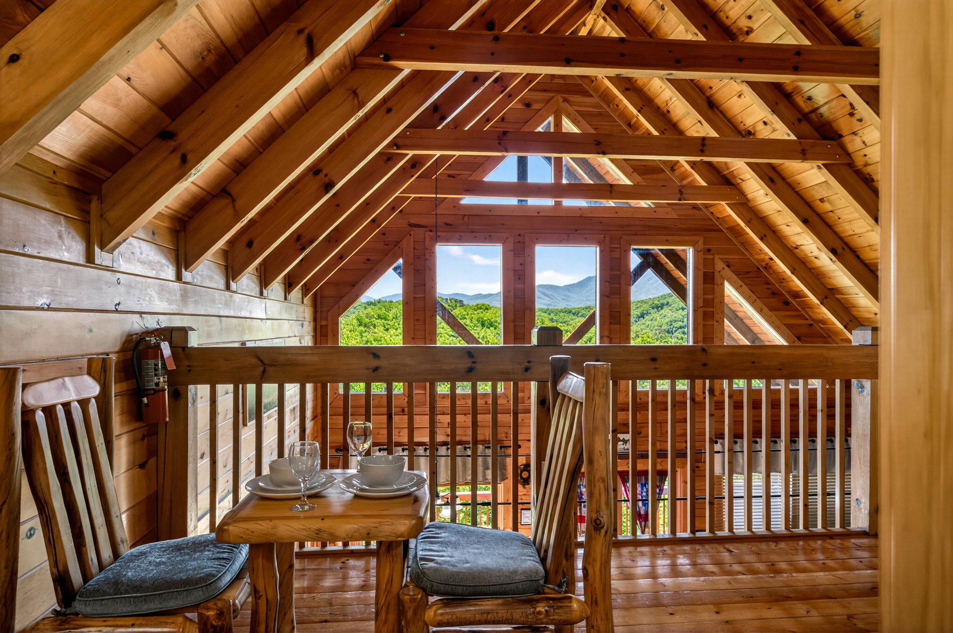 Expansive mountain vistas fill every window, while warm timber beams and a cozy dining nook create your perfect mountain retreat where nature becomes part of the decor.