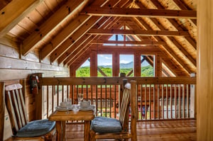 Expansive mountain vistas fill every window, while warm timber beams and a cozy dining nook create your perfect mountain retreat where nature becomes part of the decor.