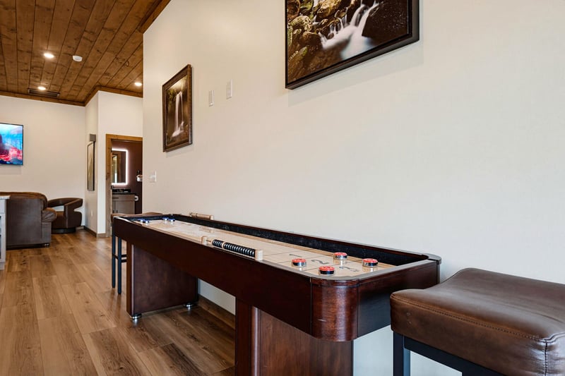 Challenge friends to a friendly game at your private shuffleboard table, complete with cozy seating and warm wood accents overhead.