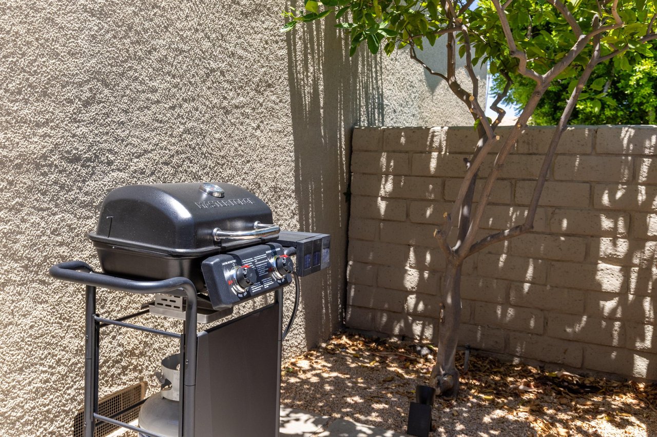 Front patio has additional table and chairs, BBQ, and access to the patio connected to the guest bedroom.