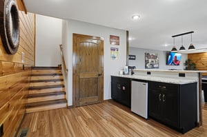 Your cozy retreat features a modern kitchenette with granite counters and stainless appliances, warm wood accents, and charming rustic details that invite you to relax and feel right at home.