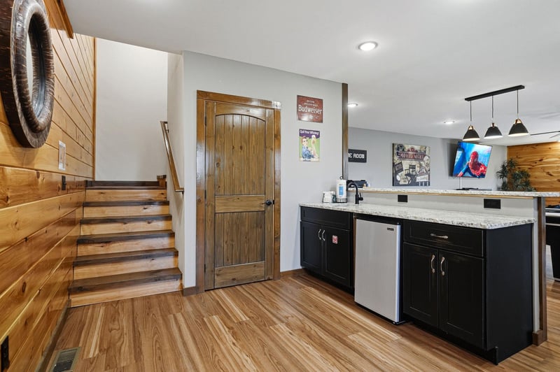 Your cozy retreat features a modern kitchenette with granite counters and stainless appliances, warm wood accents, and charming rustic details that invite you to relax and feel right at home.