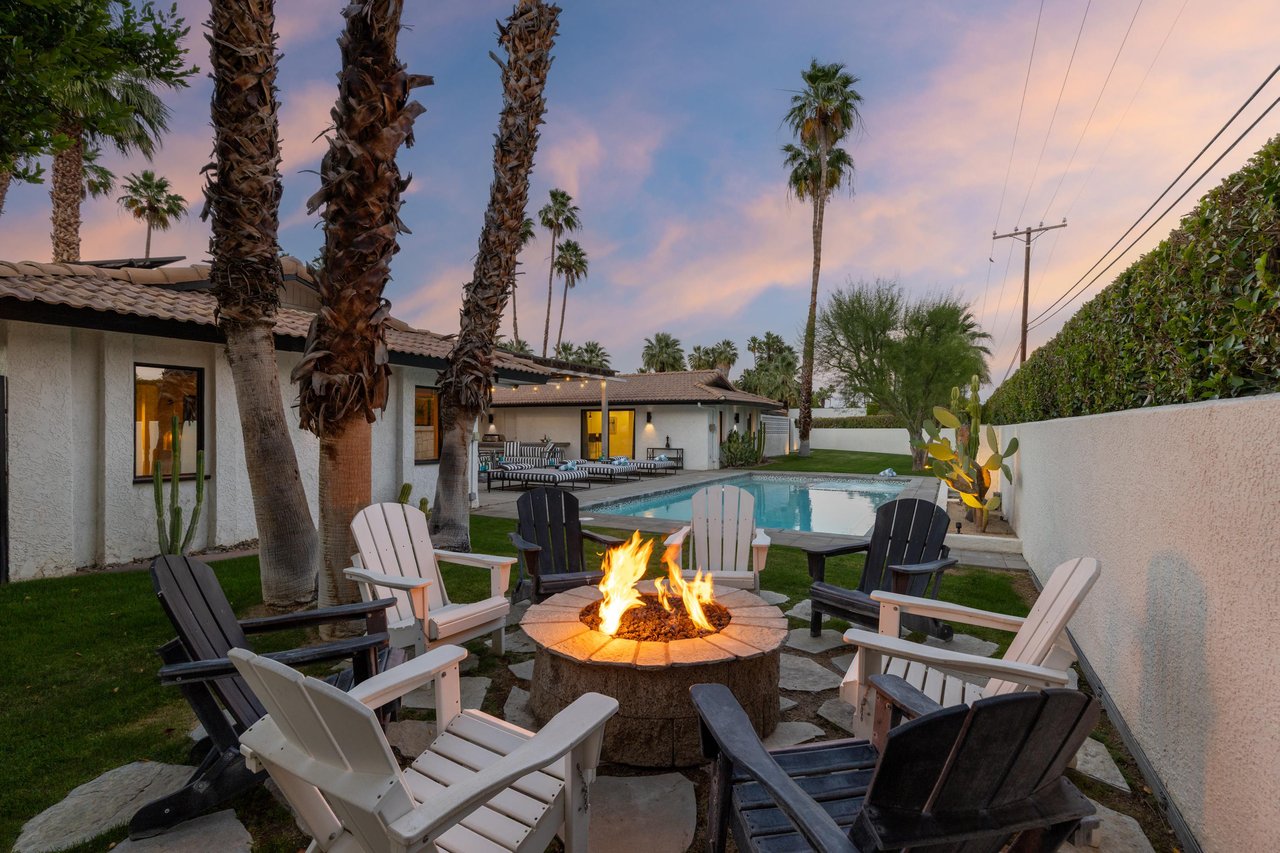 Outdoor firepit with seating for 8 overlooking the pool and spa.
