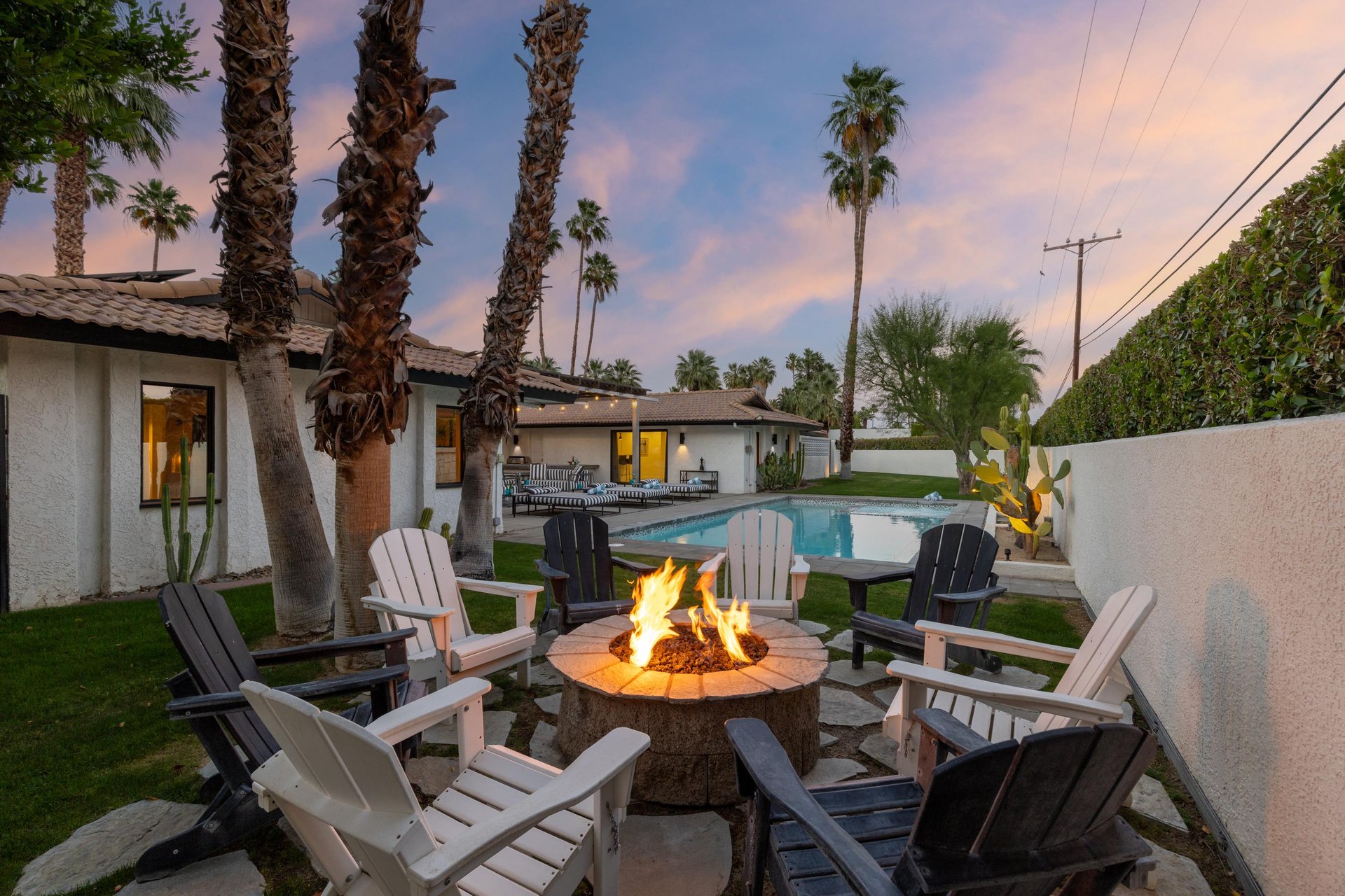 Outdoor firepit with seating for 8 overlooking the pool and spa.