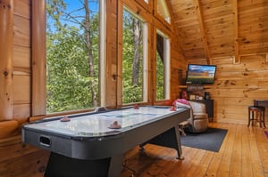 Unwind in your private game room, where floortoceiling windows frame peaceful forest views. Challenge friends to air hockey or sink into a cozy chair with your favorite beverage from the coffee bar.