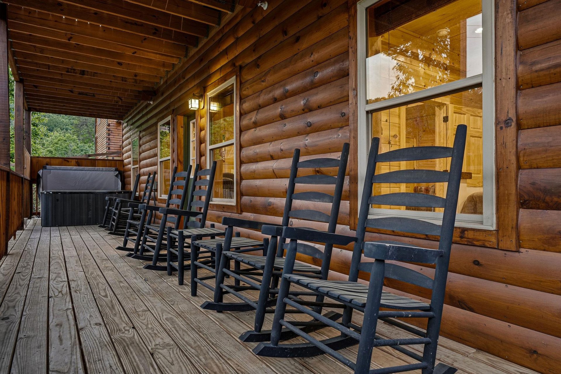 Picture yourself unwinding in your own rocking chair on this spacious covered porch, soaking in mountain air while a private hot tub awaits just steps away.