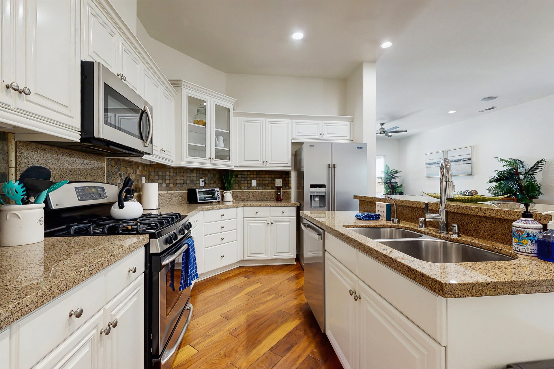 Kitchen includes cooking utensils, drip coffee maker, and toaster oven.