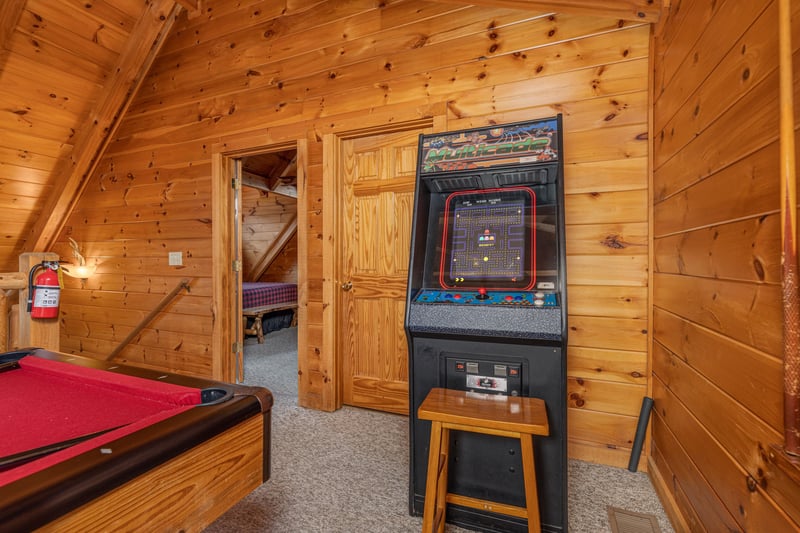 Arcade game in the loft at Livin Simple, a 2 bedroom cabin rental located in Pigeon Forge