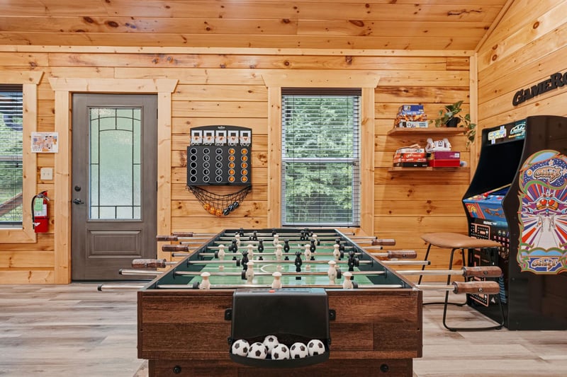 Challenge friends to foosball or arcade classics in this warm woodpaneled game room, where fun awaits after a day of mountain adventures.
