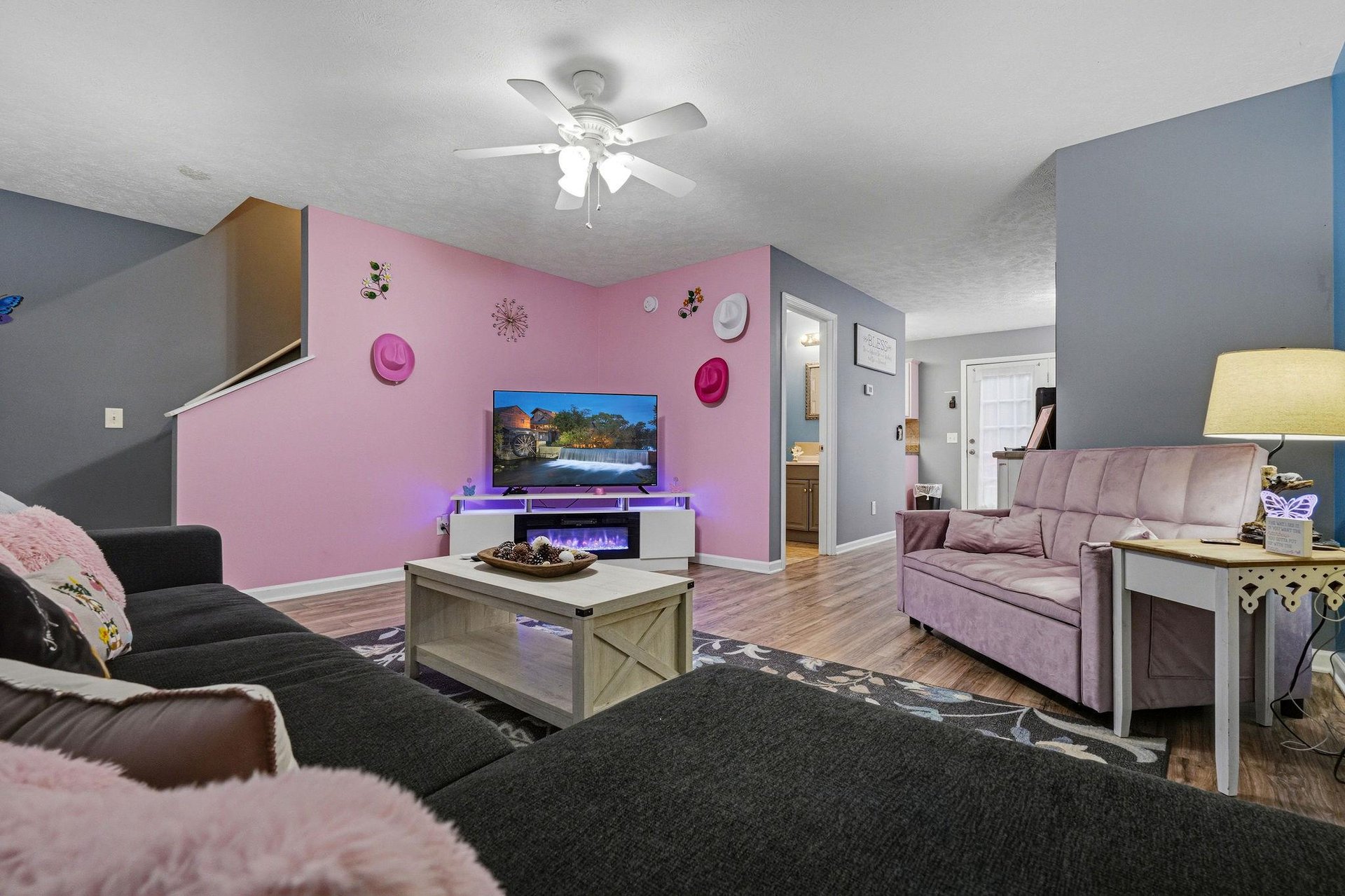 Unwind in your spacious living area with plush seating, ambient LED lighting, and a cozy electric fireplace to set the perfect mood for relaxing evenings.