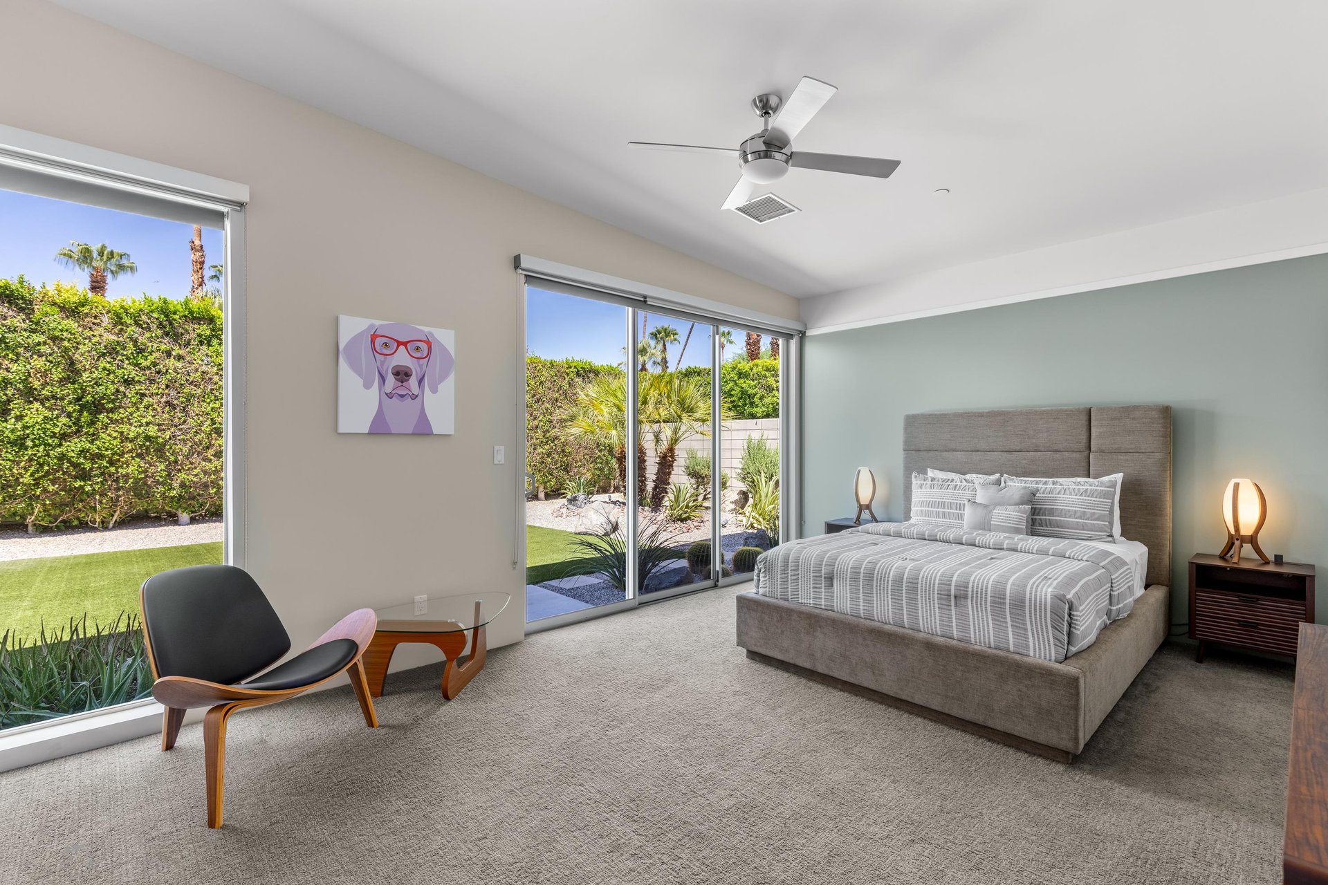 Queen size bed, large windows with natural lighting, access to the outdoor space, and ensuite bathroom.