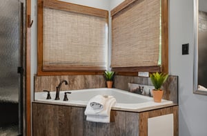 Sink into the deep soaking tub surrounded by warm wood and natural light—your private retreat for unwinding after a day of adventure.