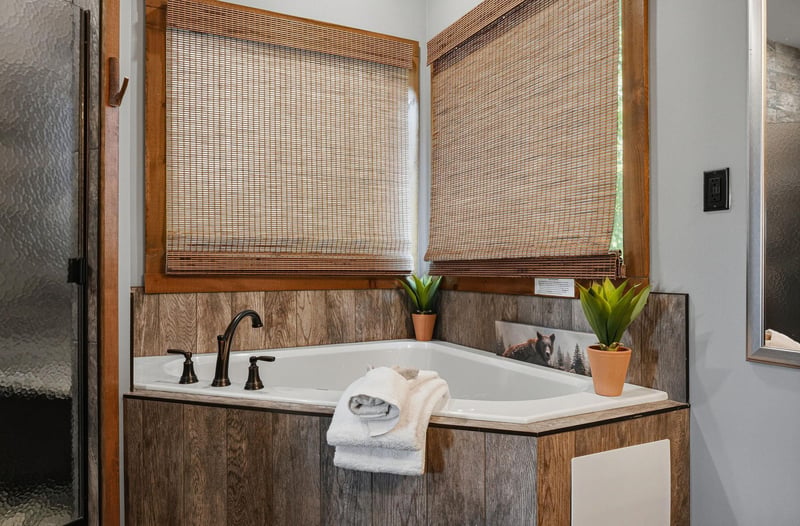 Sink into the deep soaking tub surrounded by warm wood and natural light—your private retreat for unwinding after a day of adventure.