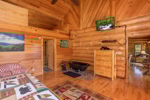 King bedroom with sleeping oft, soaker tub, and TV at Great View Lodge, a 5bedroom cabin rental located in Pigeon Forge