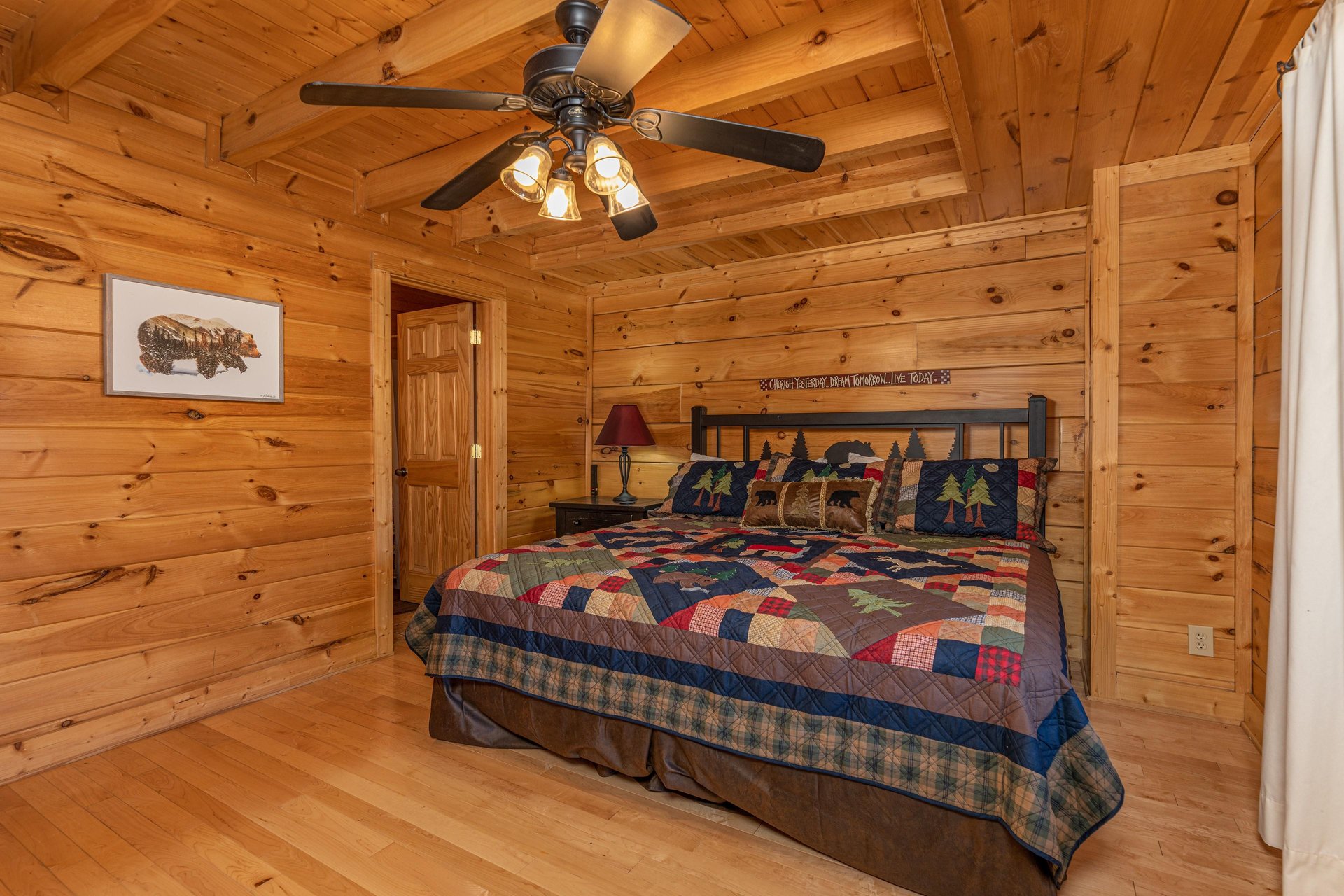 King bed, night stand, and lamp at Bears Dont Bluff, a 3 bedroom cabin rental located in Pigeon Forge